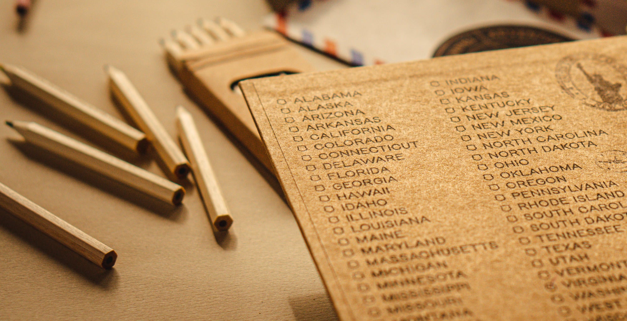 Checklist of states visited in a personalized travel scrapbook, capturing every adventure.