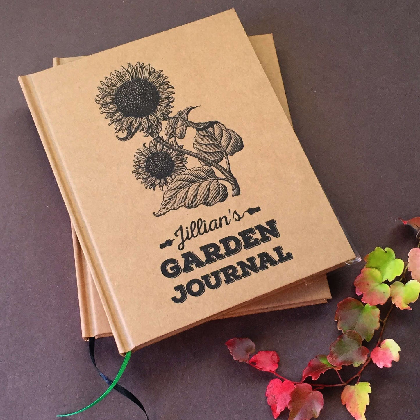 Personalized garden journal with sunflower design and text on a dark background