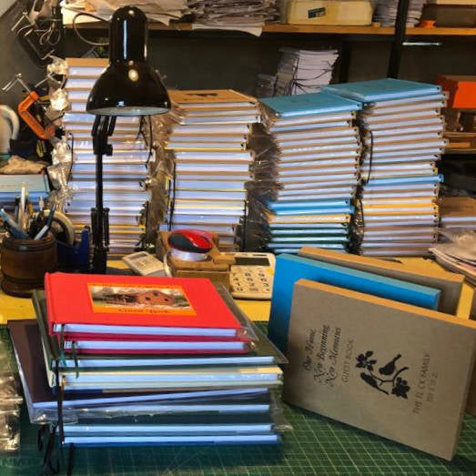 A variety of custom handbound books in different sizes, showcasing unique, high-quality craftsmanship.
