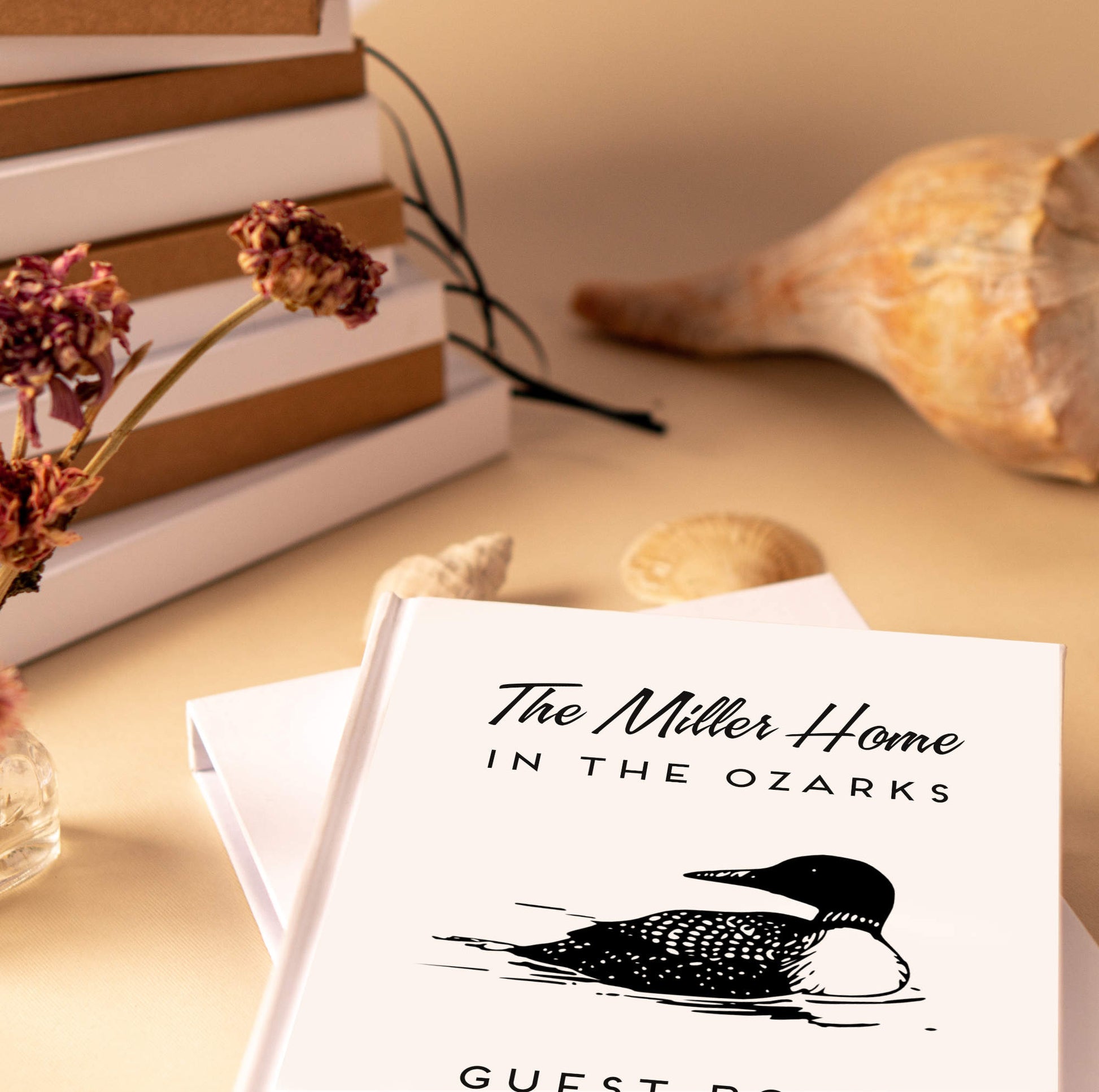 Lake House Decor. This photo is of a personalized guest book displayed on an entry way table of an airbnb rental property.