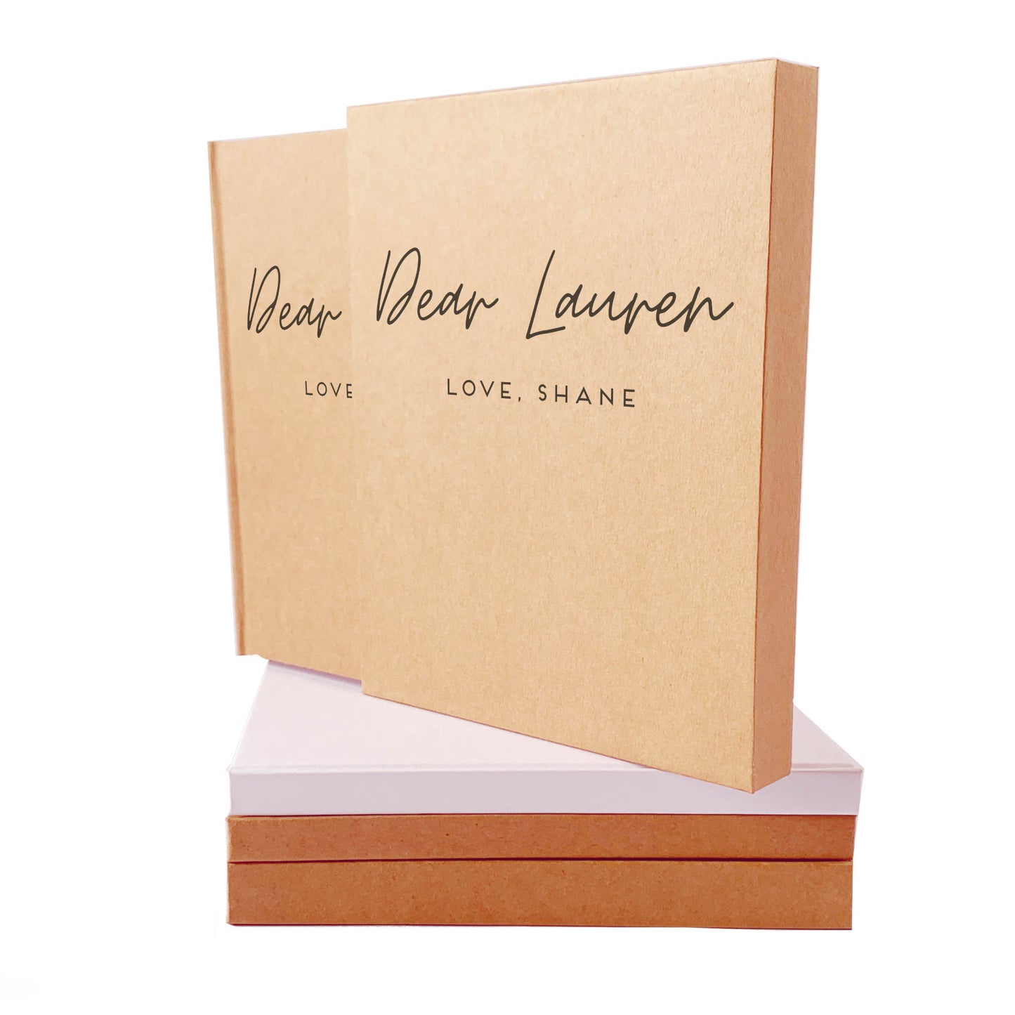 Letters to husband couple's journal with custom text on the front, poised on top of a stack of books, housed in a matching book slipcase.