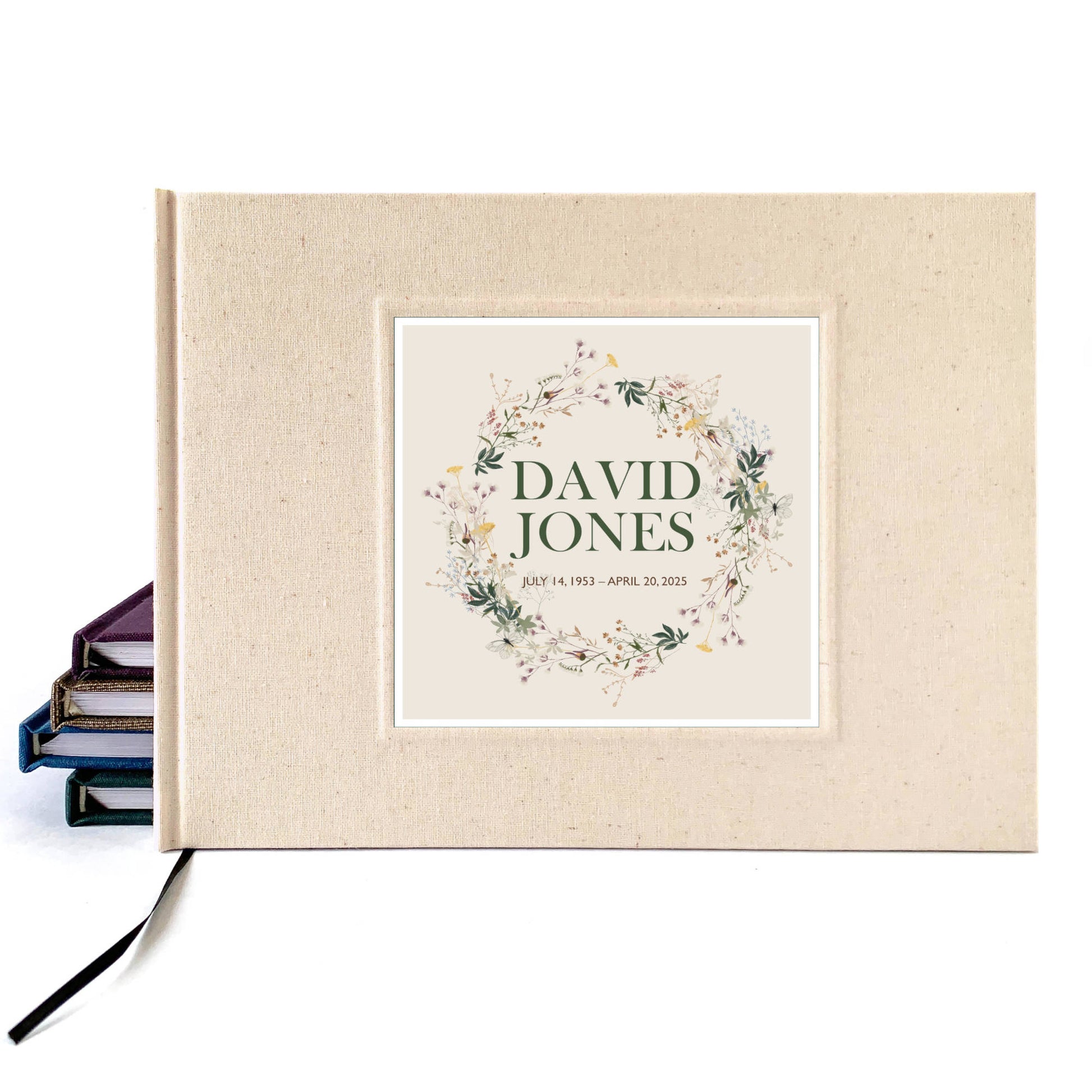 Cream linen memorial service guest book, hardback, personalized with  name on cover. The wildflower design commemorates the deceased with kindness.