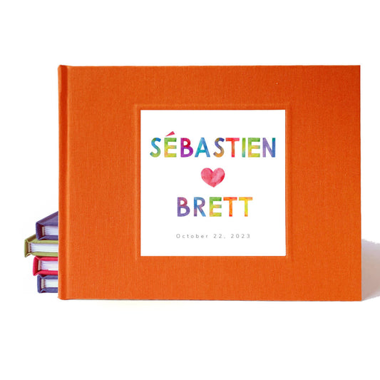 Rainbow wedding guest book with orange cover, hand-bound and customized for colorful or pride-themed weddings.