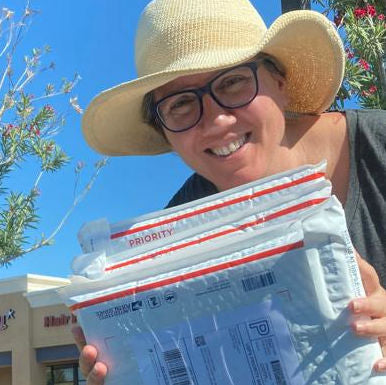 Alex preparing and shipping handbound books, ready to be sent out via USPS for Transient Books.