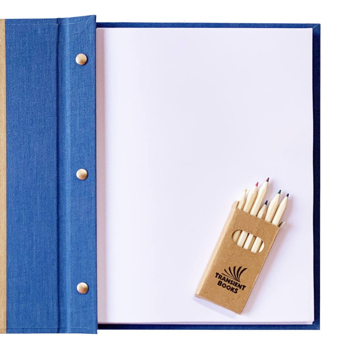 Open travel scrapbook with removable pages, featuring colored pencils for personalizing and capturing your adventures.