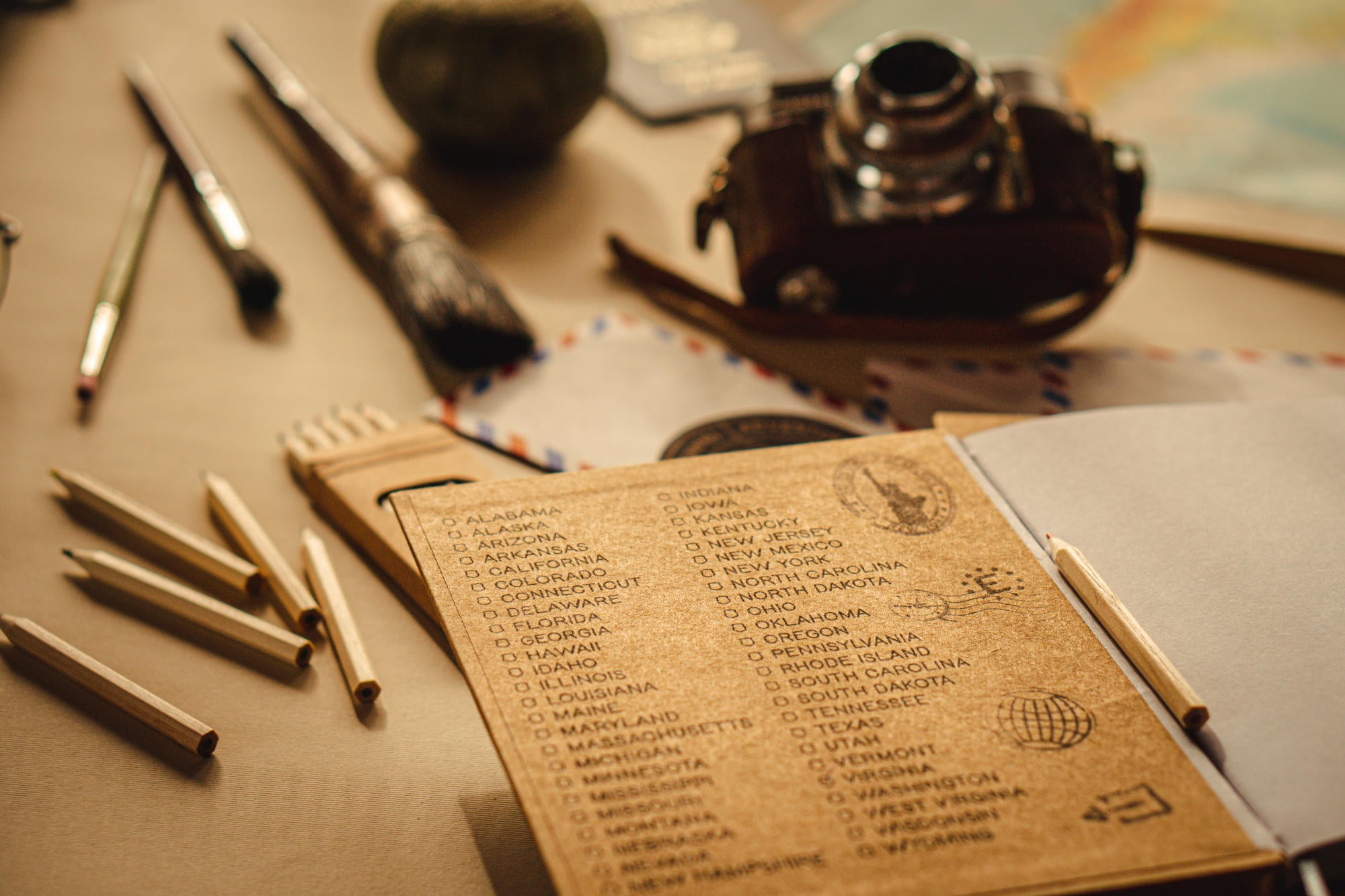 Custom traveler's notebook with a checklist of states visited. Handcrafted, personalized, and designed for adventure seekers.