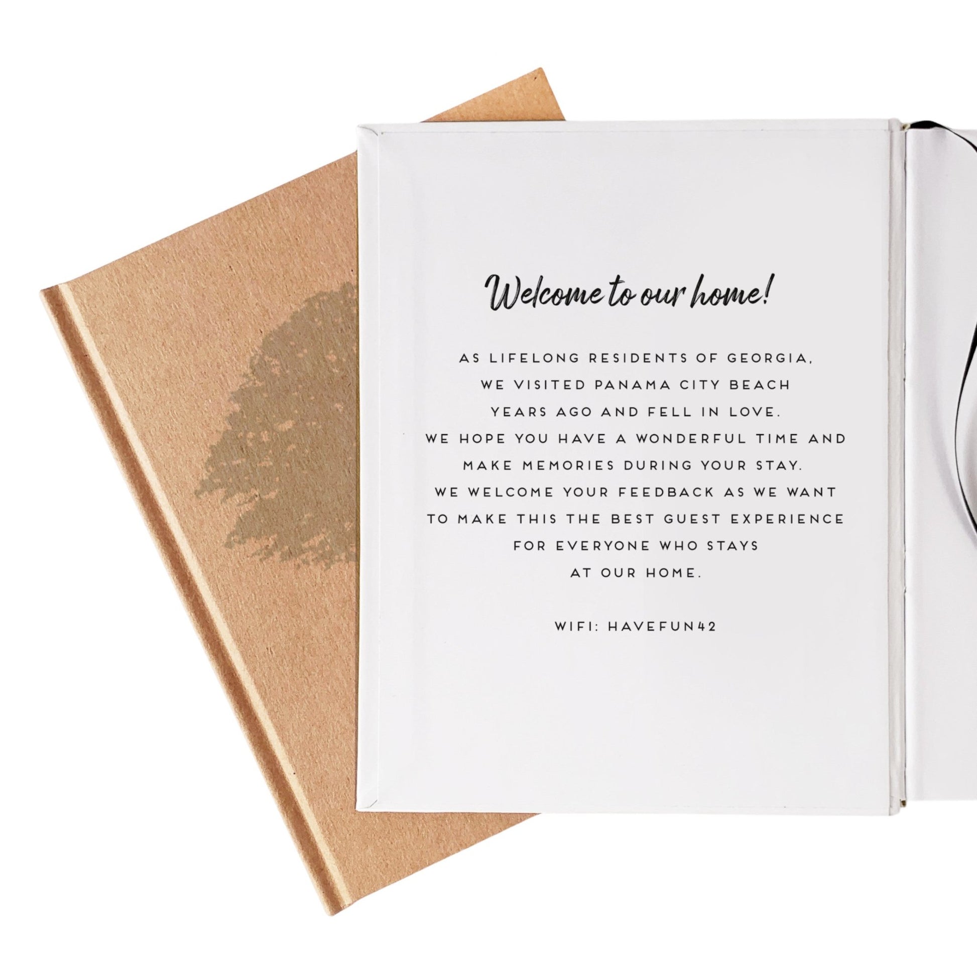 A handbound book open to the inside front cover which has a personalized message for guests printed there. Ideal customization for airbnb owners needing to welcome and inform guests.
