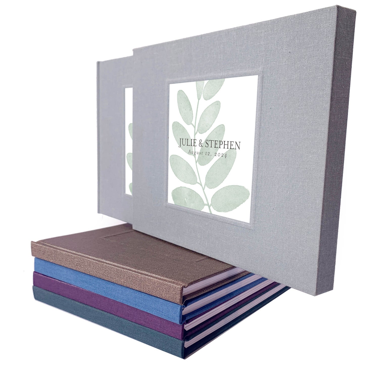 Rustic wedding guest book with printed inlay leaf design and custom names on a gray linen cover, housed in a matching book slipcase.