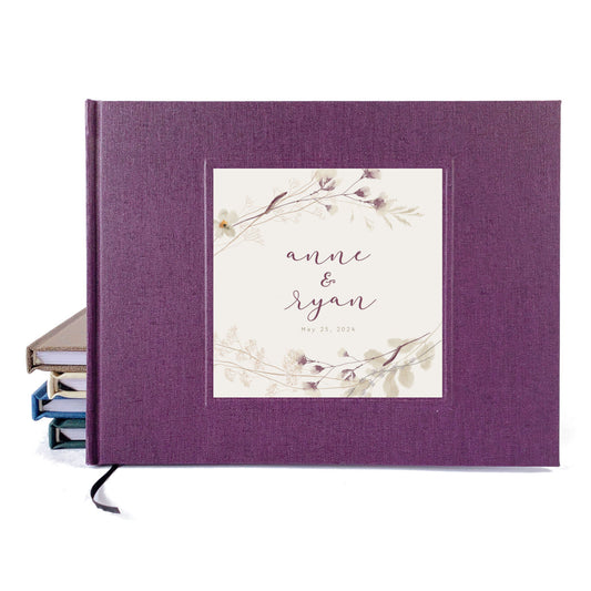 Wedding guest book with dark purple cover and personalized plum floral design.