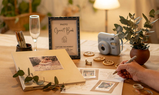 Wedding Guest Book table with photo guest book, instant camera, table sign, decorations, and pens.