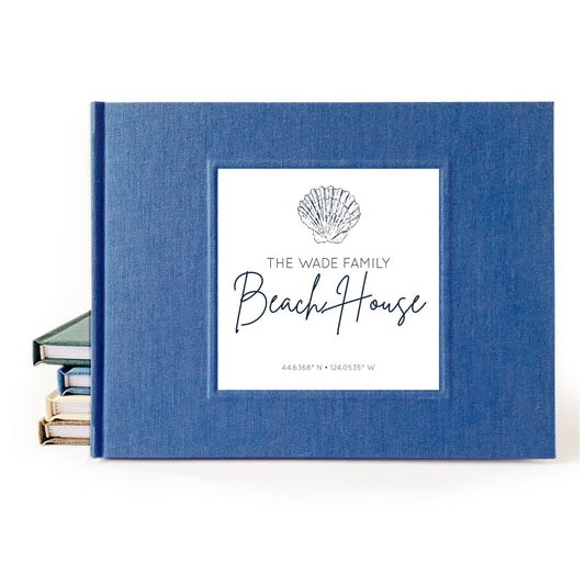 Personalized beach house guest book in navy blue linen with custom text and seashell artwork. Latitude and longitude included on cover. Hard back, handmade. Very high quality and modern.