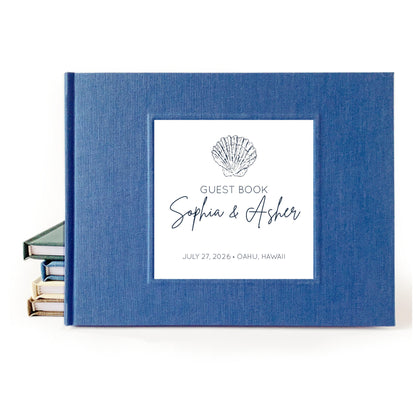 Custom beach wedding guest book with hardback blue linen cover and coastal design for engaged couple