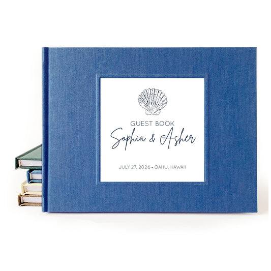 Custom beach wedding guest book with hardback blue linen cover and coastal design for engaged couple