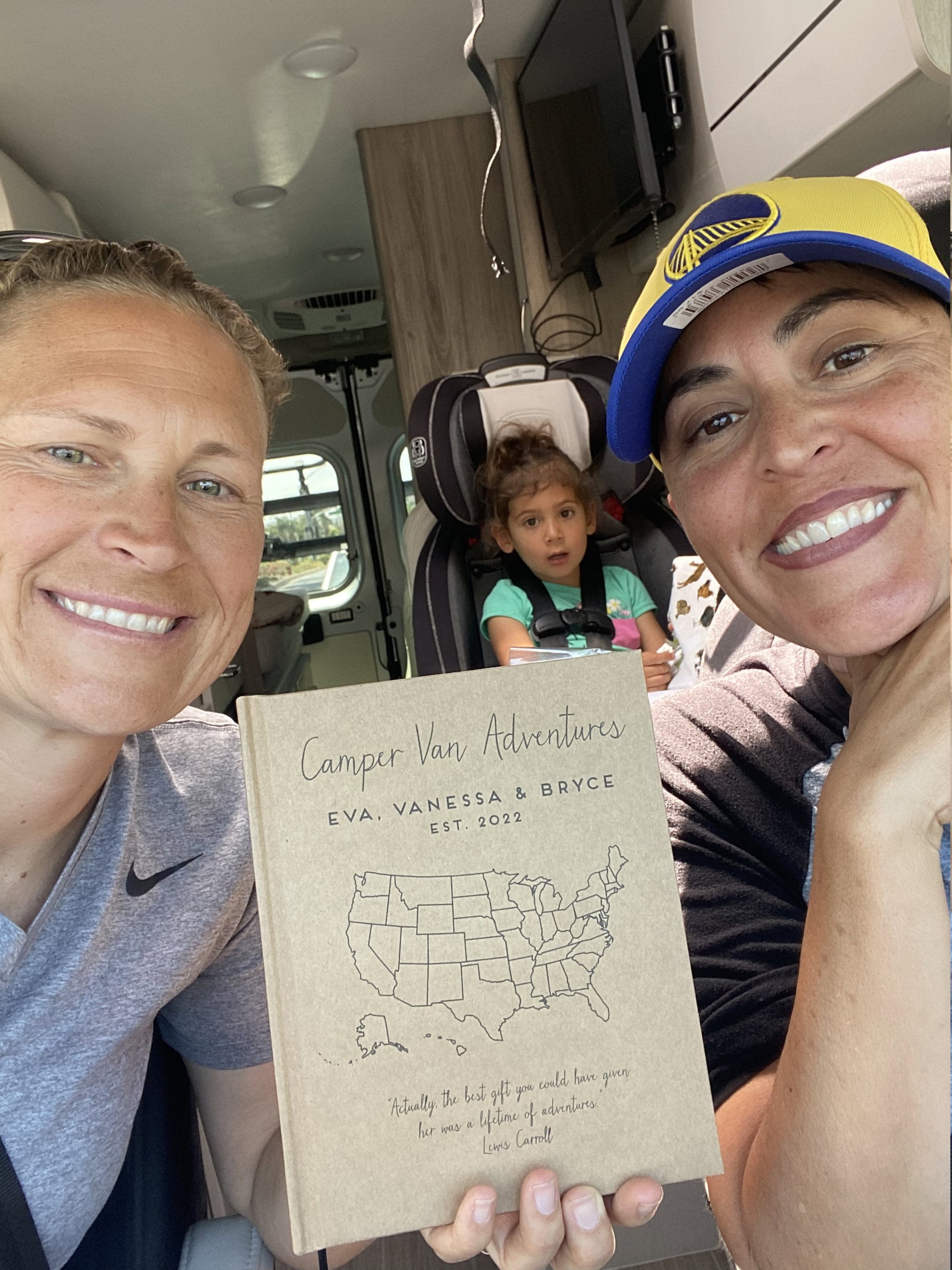 Two women and a young girl enjoying one of Transient Books' personalized travel diaries – perfect travel gifts for women.