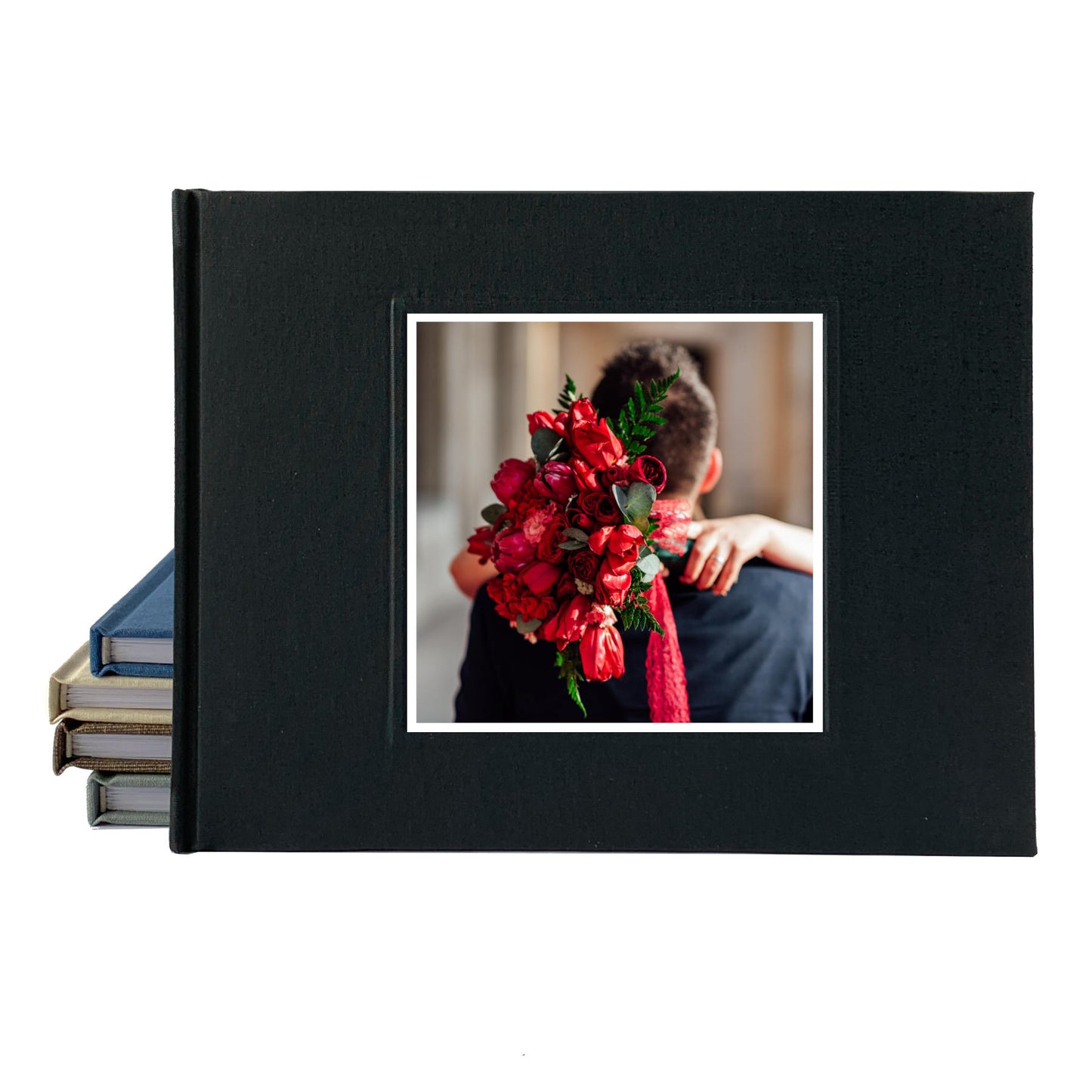 Black linen wedding guest book with engagement photo on the cover of a couple with a huge red bouquet of roses.