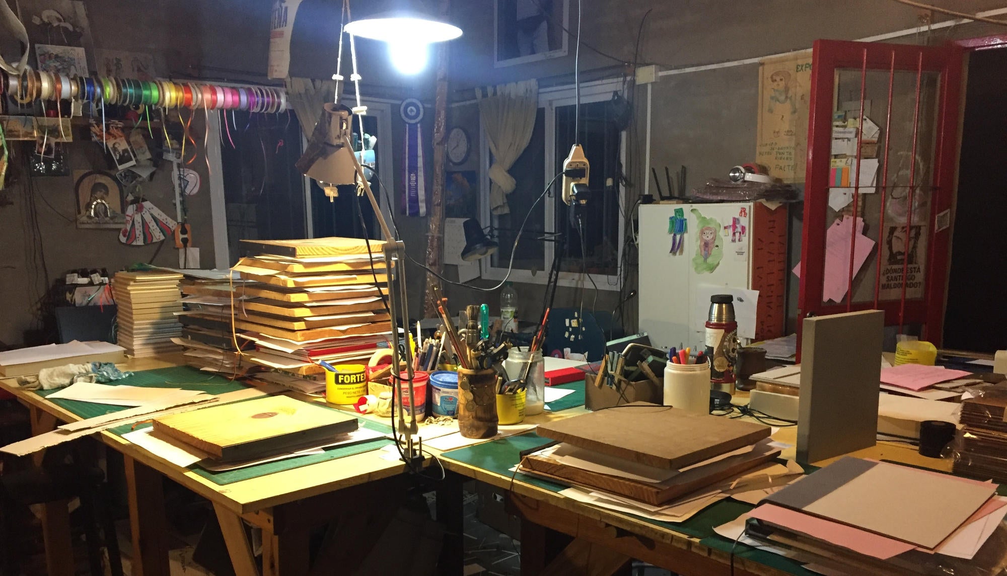 The Transient Books Bindery on a typical work day with work benches full of custom hand bound books in the process of being made. Lots of bookbinding tools, drying boards, creative energy.