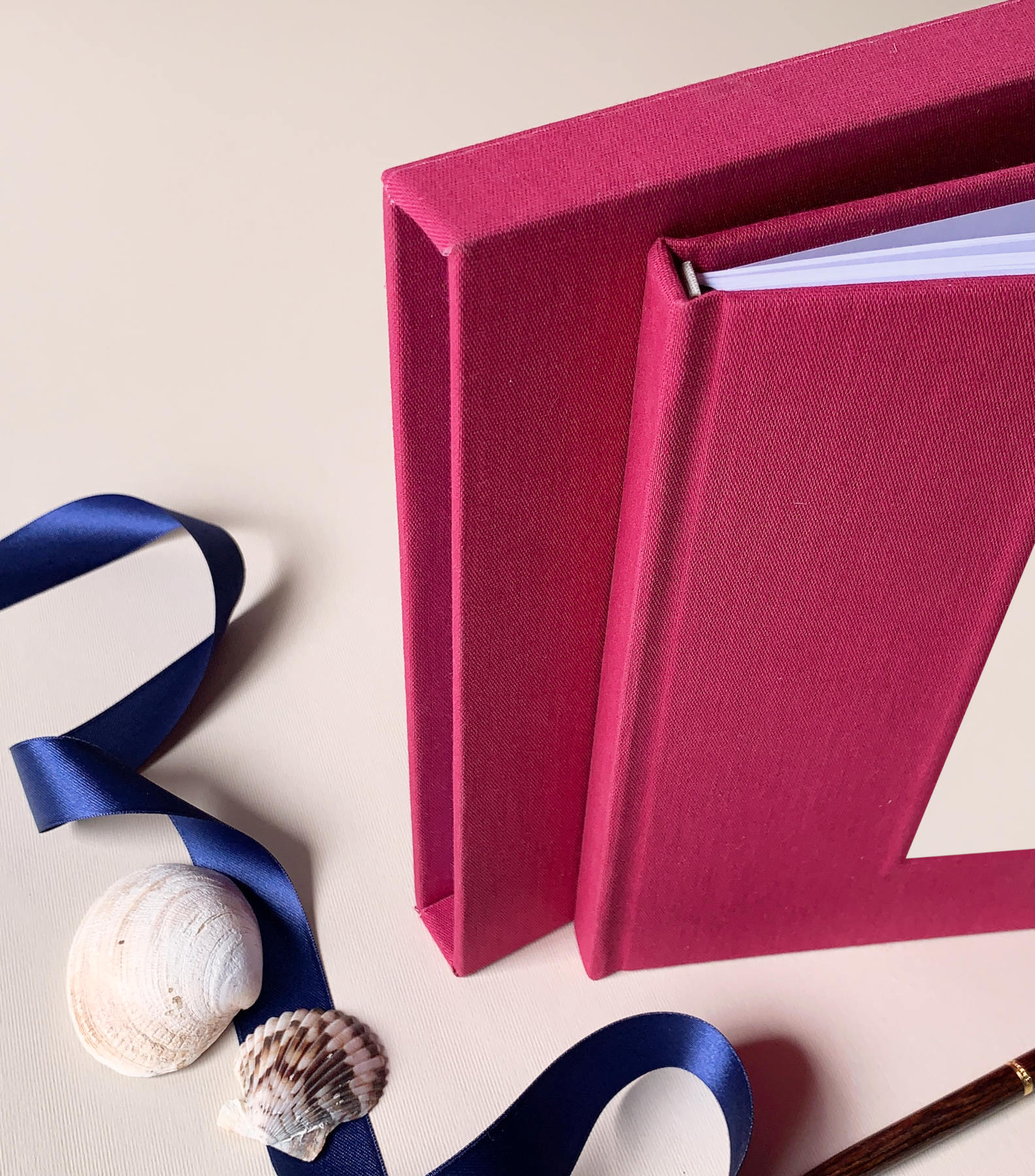 Linen hardback wedding guest book personalized for bride and groom keepsake, housed in a matching book slipcase.