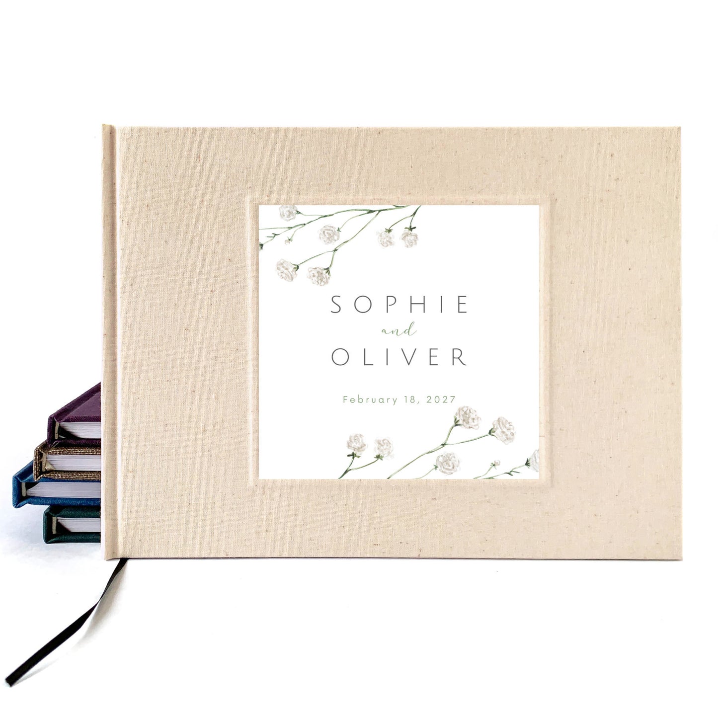 Cream linen wedding guest book with a botanical cover inlay personalized with names and date of bride and groom and their wedding.