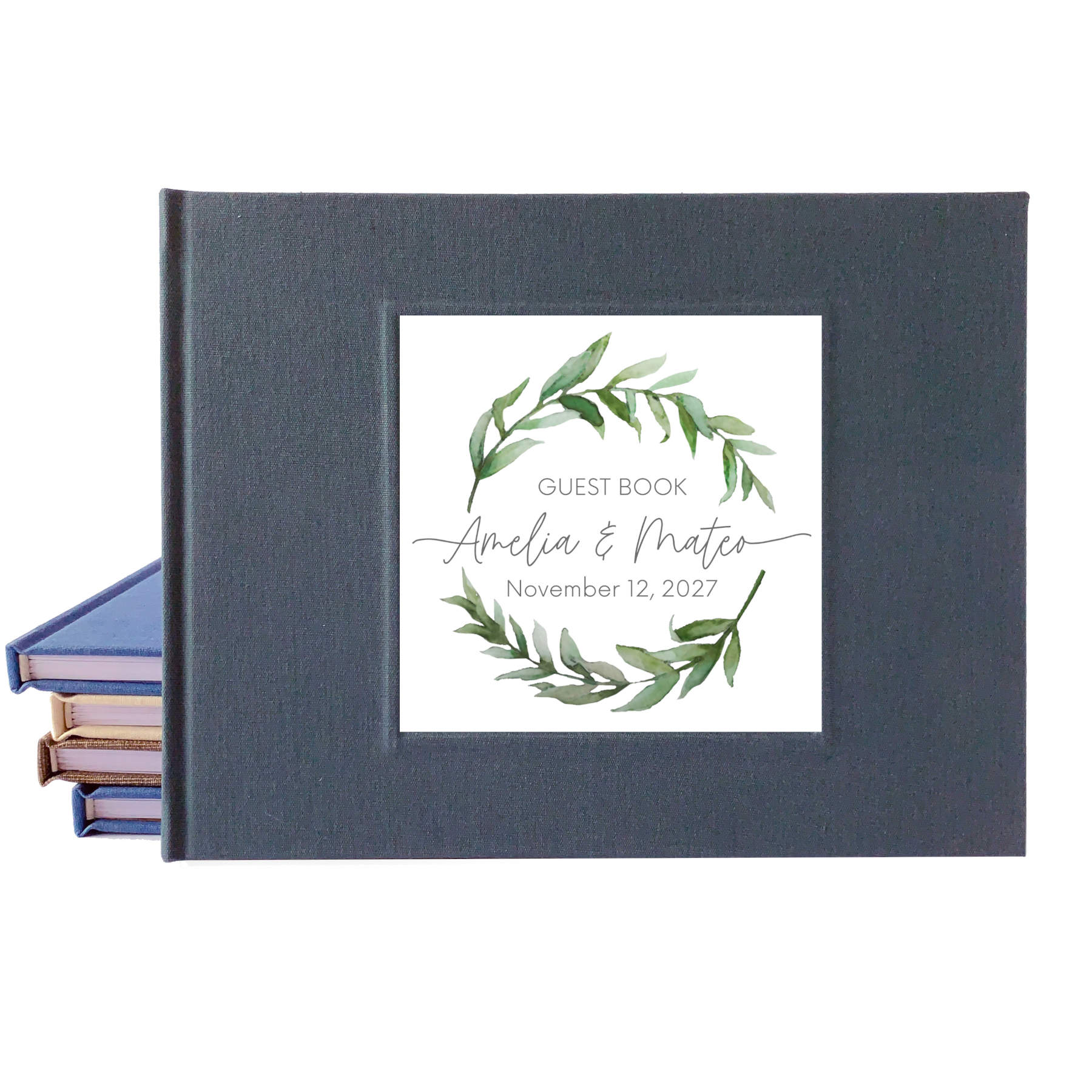 Dark gray linen wedding guest book with a personalized watercolor wreath design on the front that uses a script font for the names of the bride and groom.