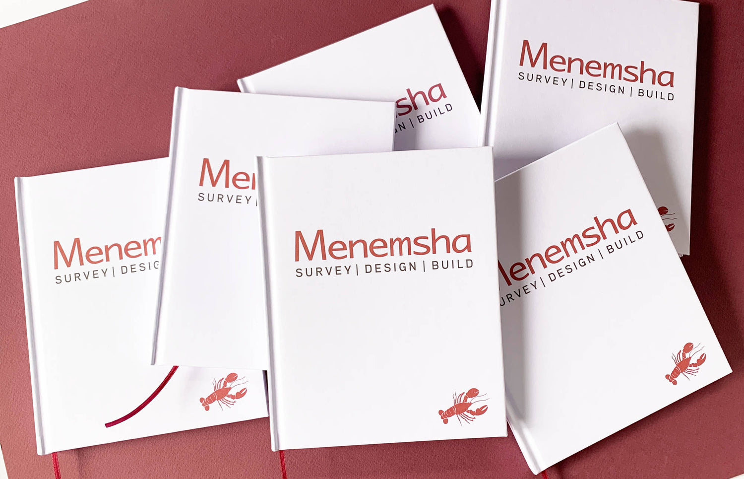 Menemsha branded bulk journals on a red background