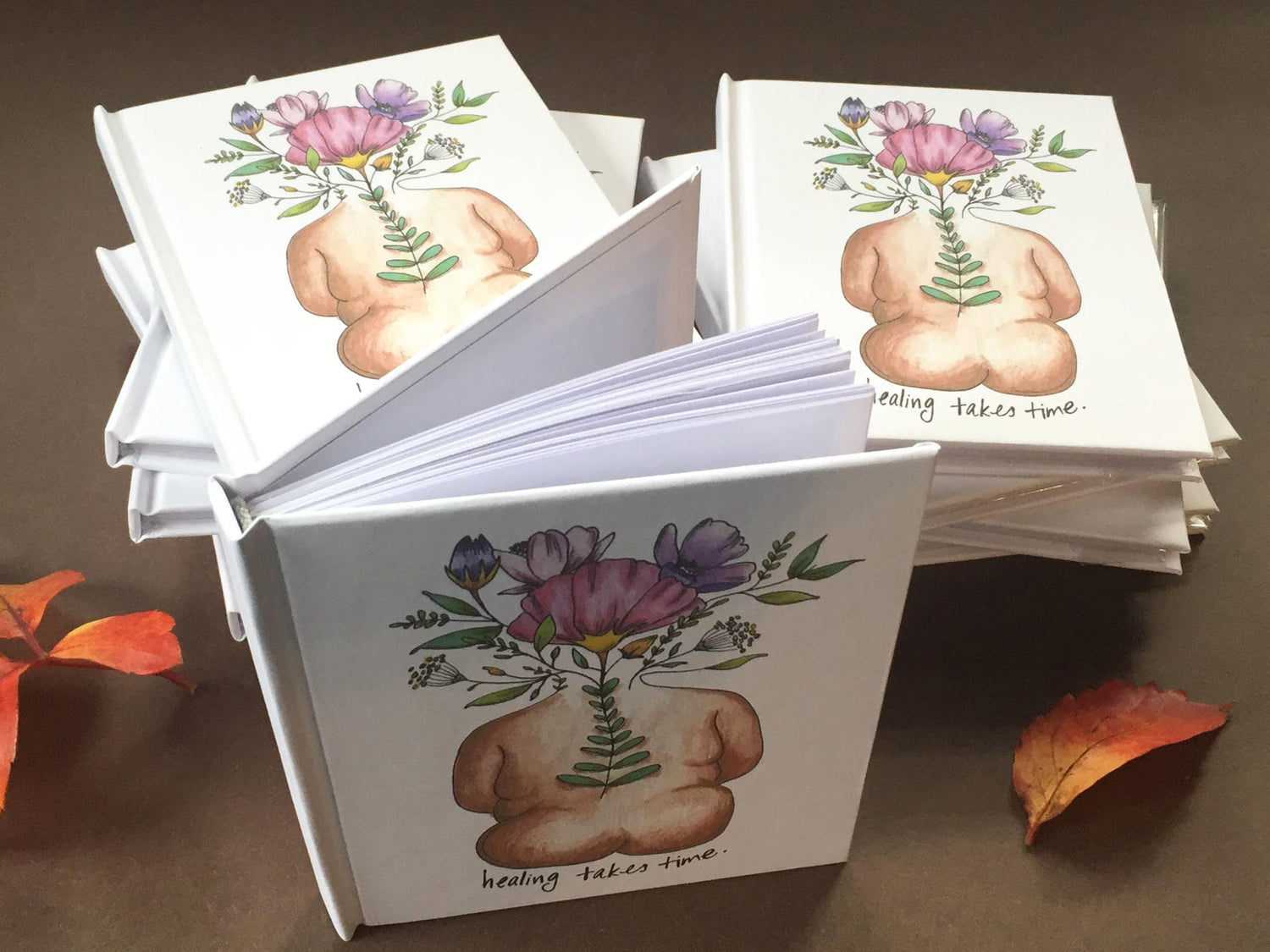Set of bulk journals with personalized artwork on the covers.