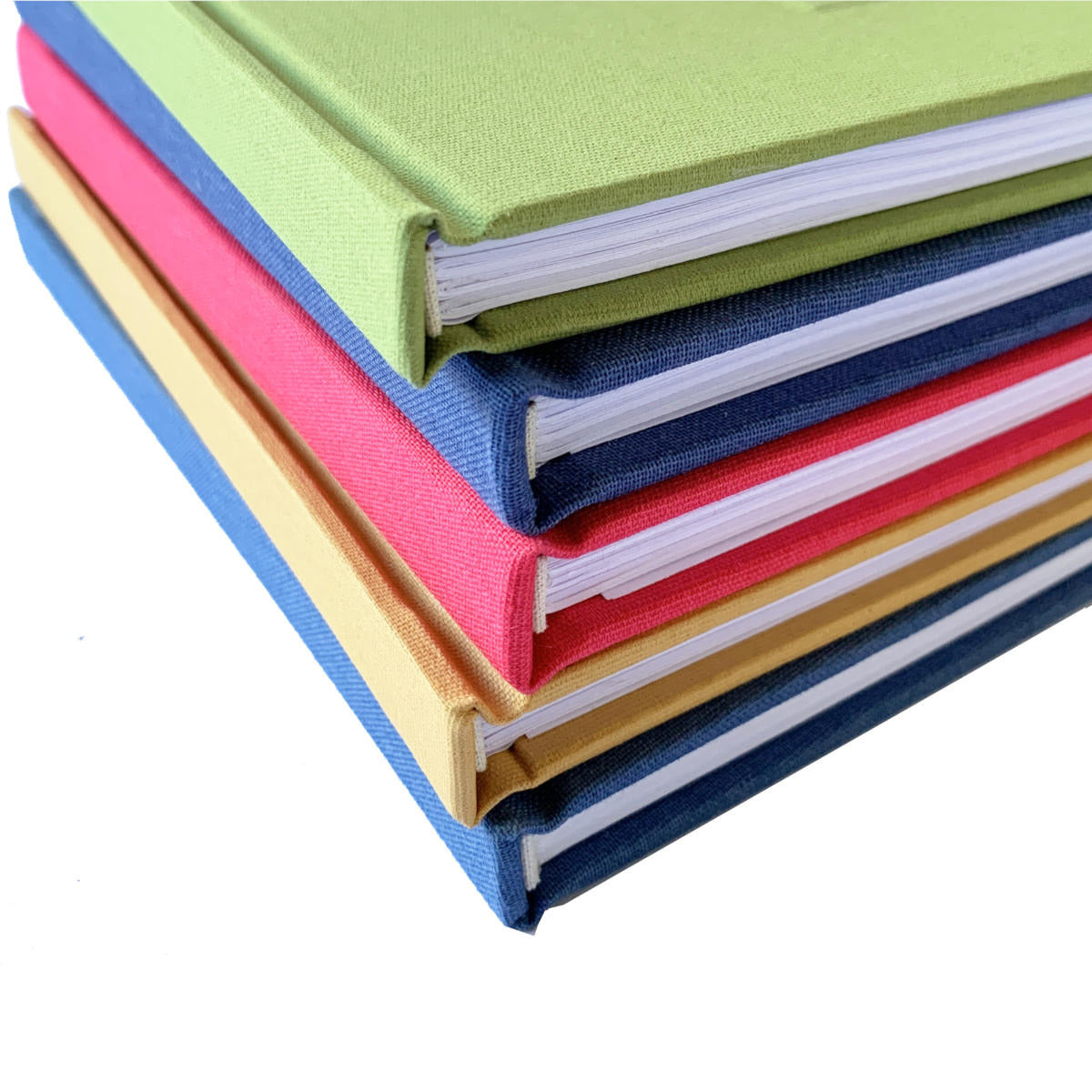 Close-up of a stack of handmade books with linen binding canvas covers in various colors.