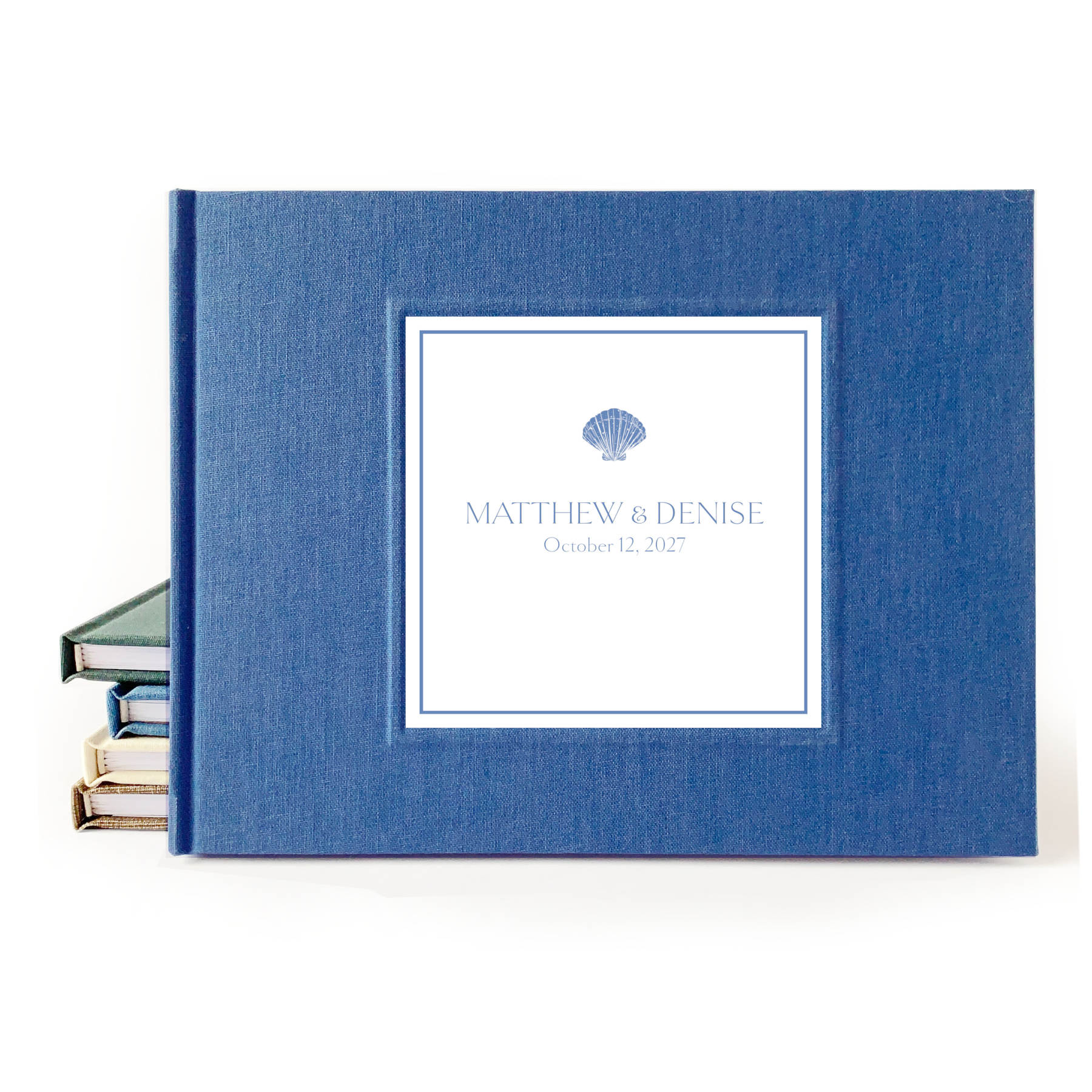 Blue linen hardback wedding guest book with custom names and wedding date on the cover.