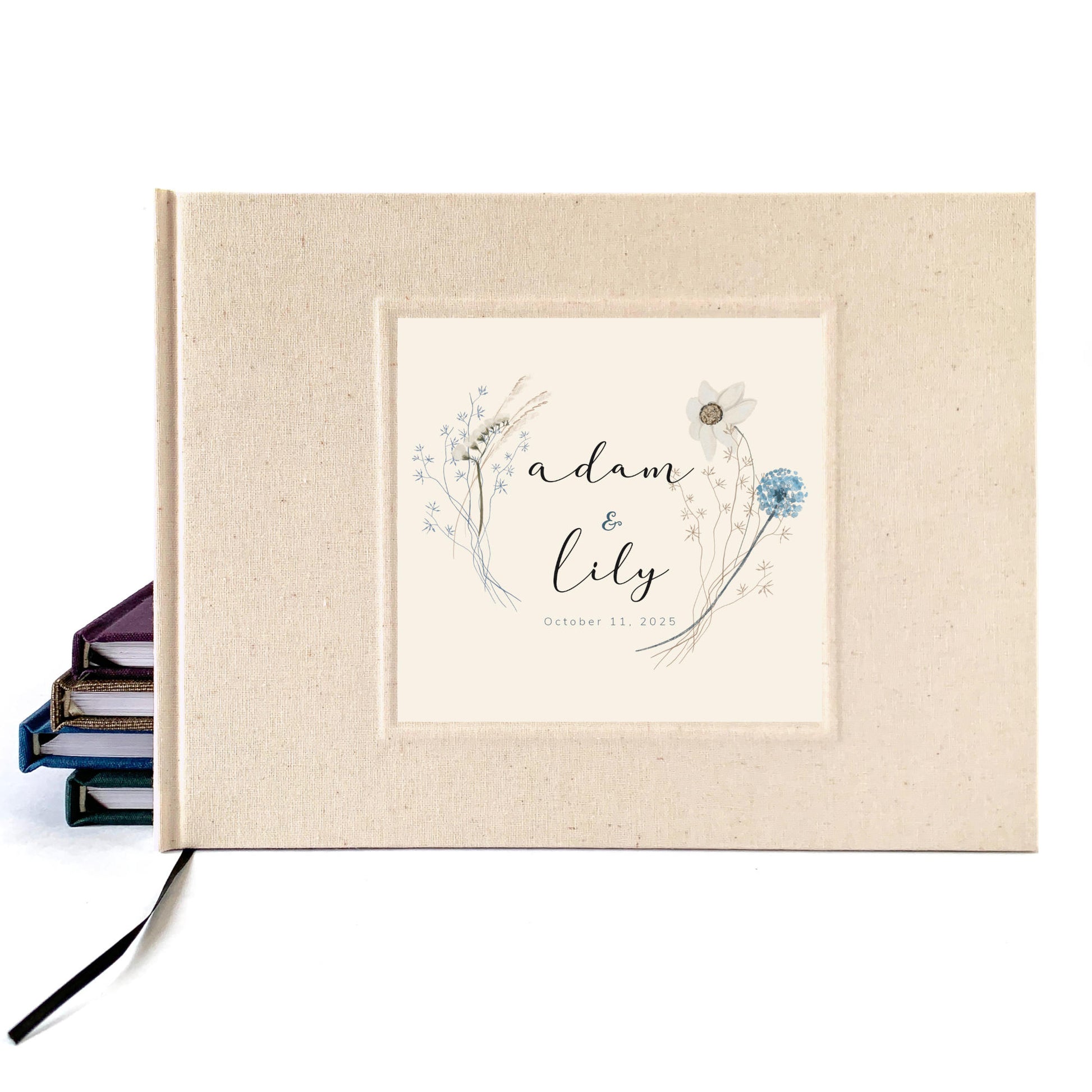 Cream linen wedding guest book for outdoor, natural boho commitment ceremony. Personalized wildflower bouquet design on cover with names and wedding date. 