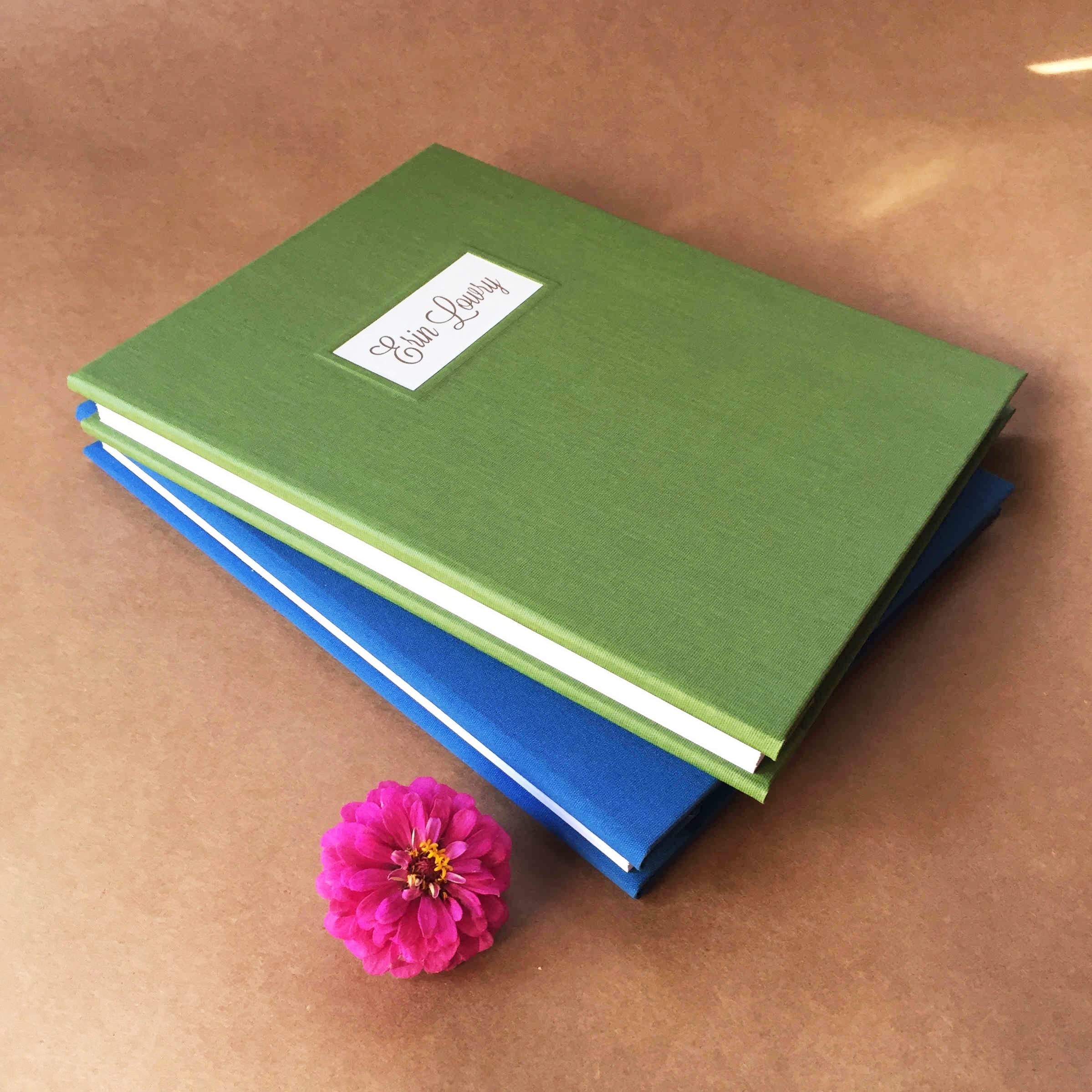 Two custom binders, each uniquely designed and personalized for vacation rental homes.