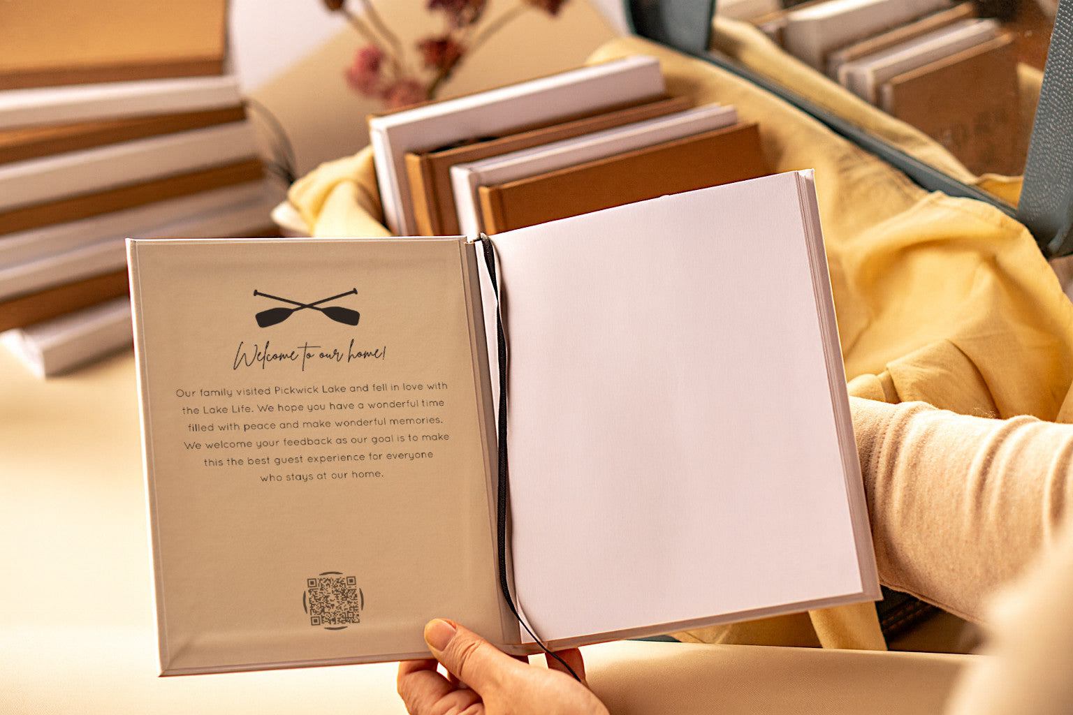 Custom welcome message printed on the inside of a vacation home guest book being held in the air for guests to see.