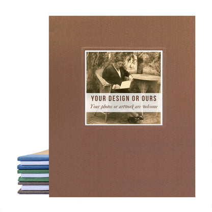 Brown linen recipe binder with a custom photo of a grandmother on the cover looking at her own recipe book. The binder is standing upright, leaning on other recipe binders, with a white background.