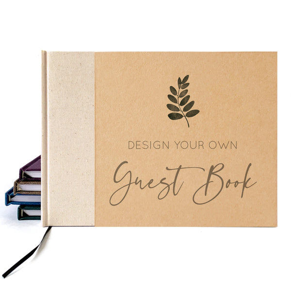 A kraft paper guest book with a cream linen spine and a dark brown printed leaf logo and the words 'DESIGN YOUR OWN Guest Book' on the front, shown on a white background with a stack of other books partially visible behind it.
