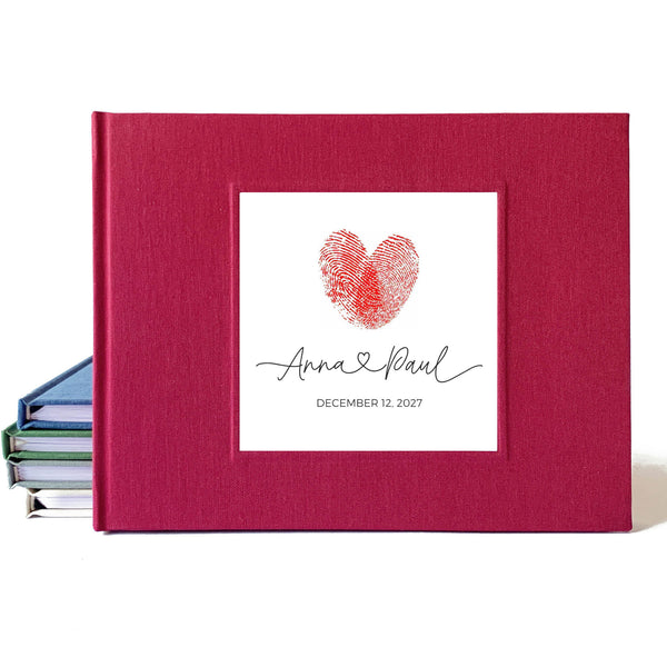 Burgundy linen wedding guest book with a fingerprint heart design and text on a white background.