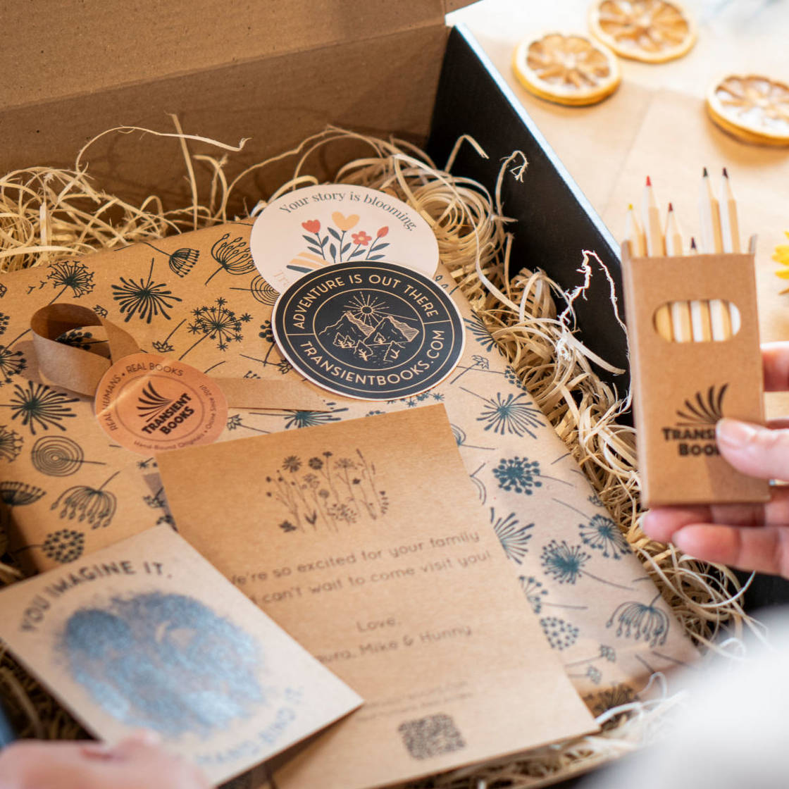 Gift Box for books with gift wrapped handbound book, stickers, postcard, gift note, colored pencils.