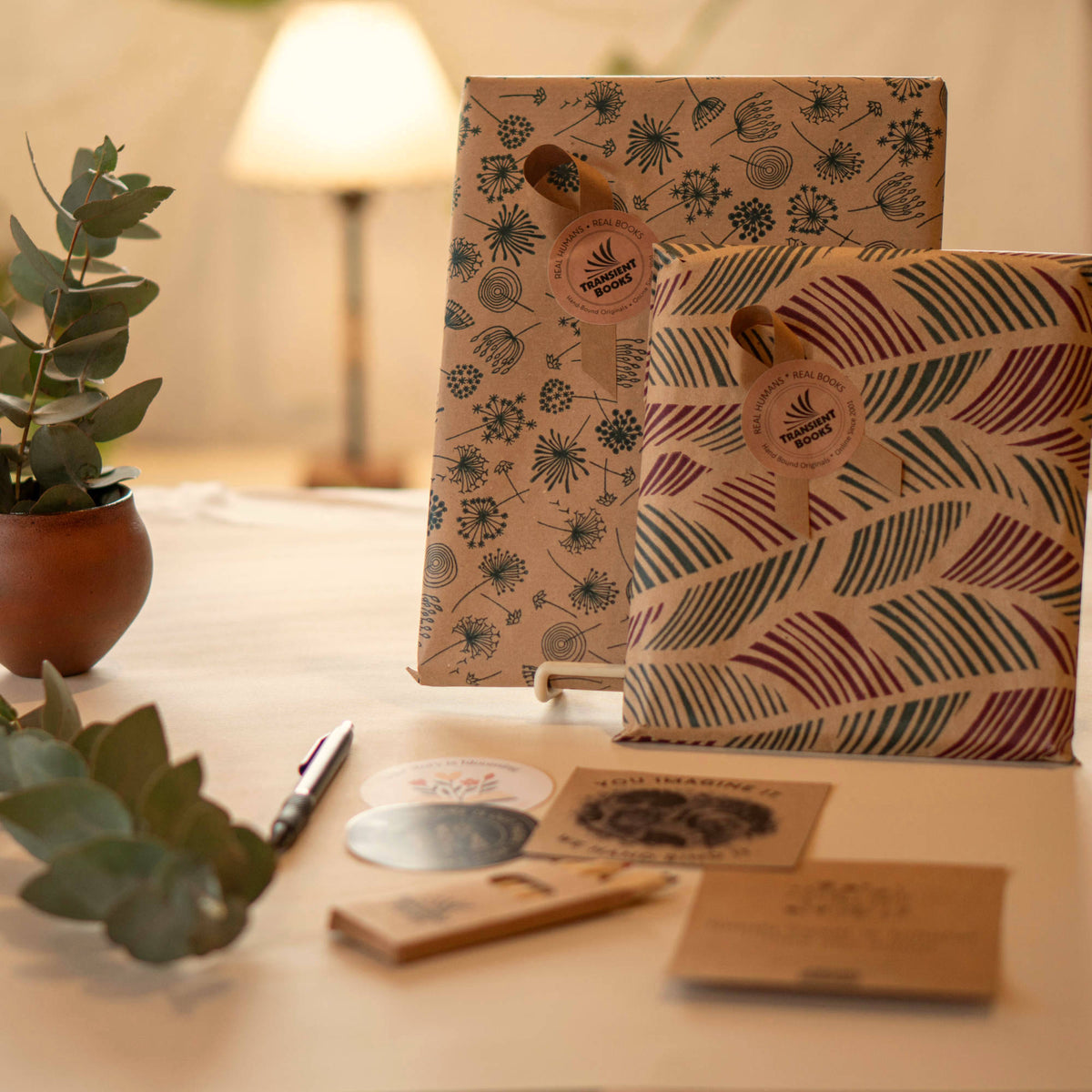 Warm, rustic, nature oriented gift wrapped packages with gift note and dried greenery.