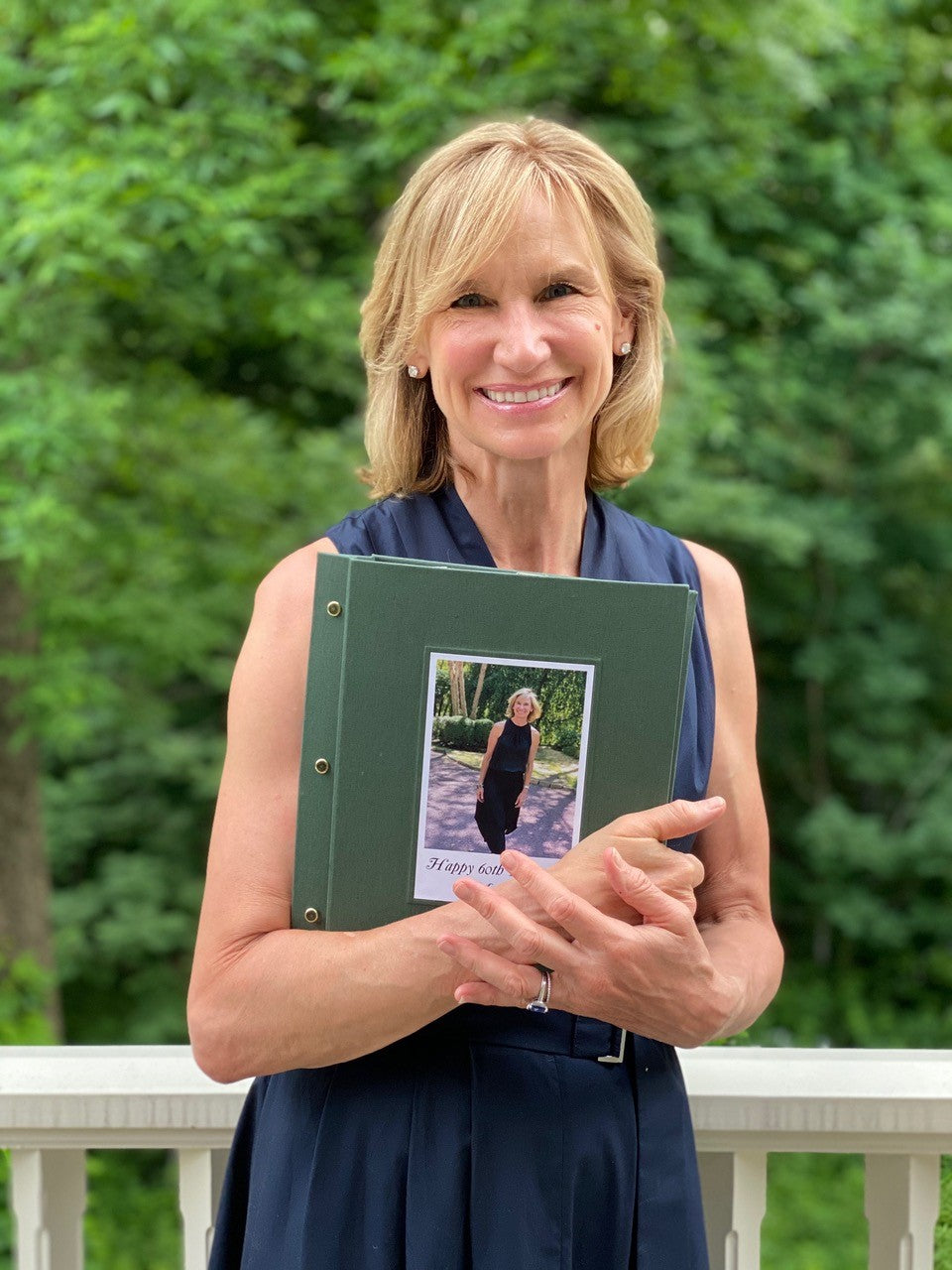 Property owner holding a personalized house rules binder for Airbnb guests.