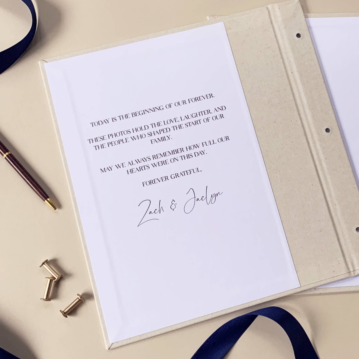 close up of Elegant custom wedding guest book swith textured linen cover open to show the custom printed inside front cover.