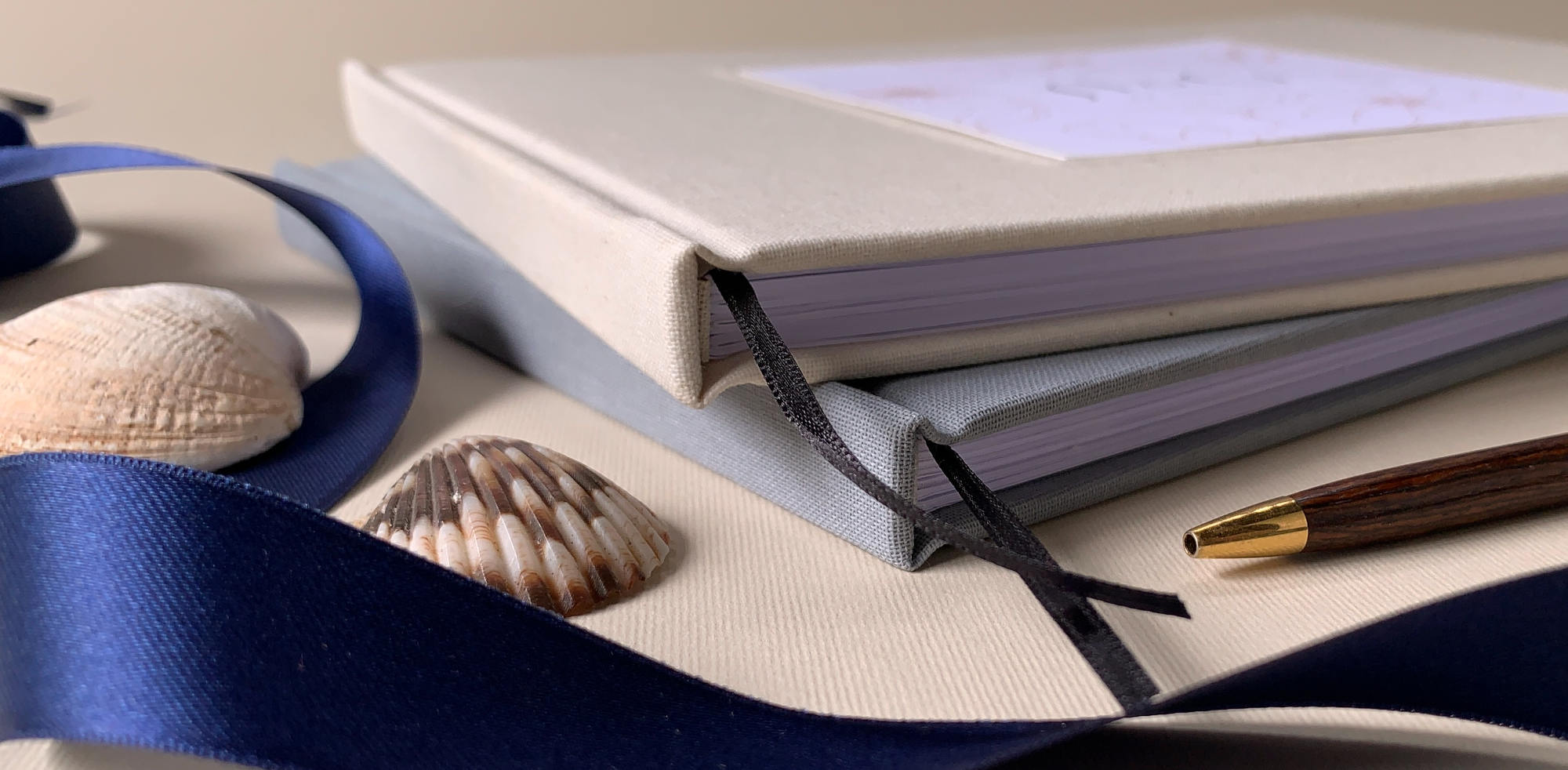 close up photo of Elegant custom wedding guest books with textured linen cover and thick archival pages
