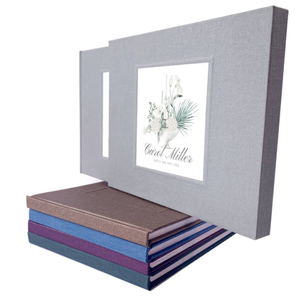 Personalized funeral guest book in a matching book slipcase with white floral bouquet design and custom name and dates on the cover.