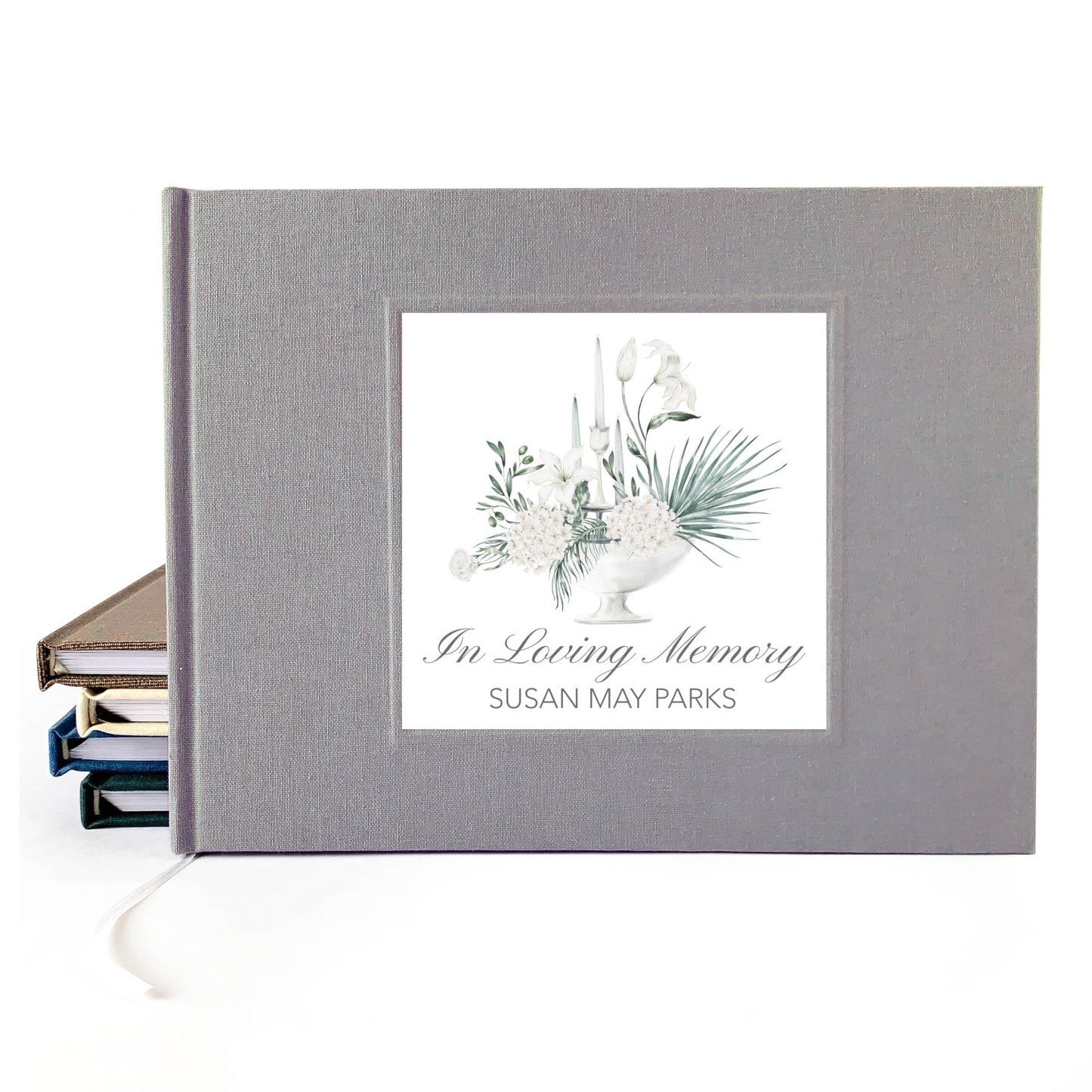 Personalized funeral guest book with white floral bouquet design and custom name and dates on the cover.