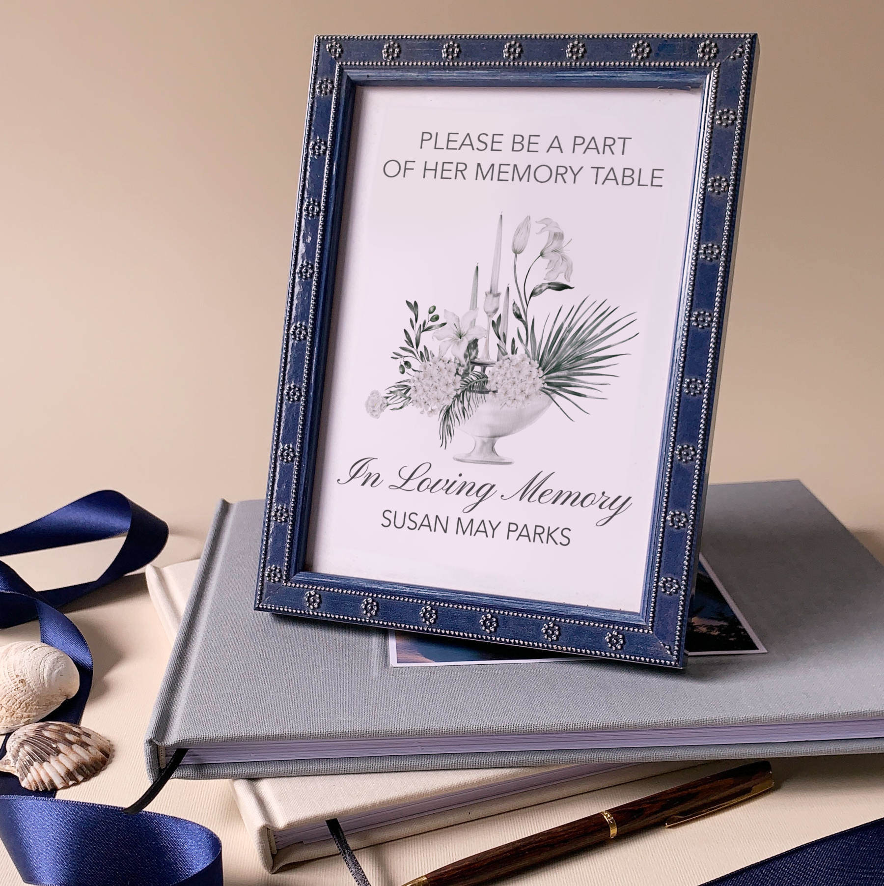 Memory table sign for celebration of life ceremony with floral design and text on a beige background