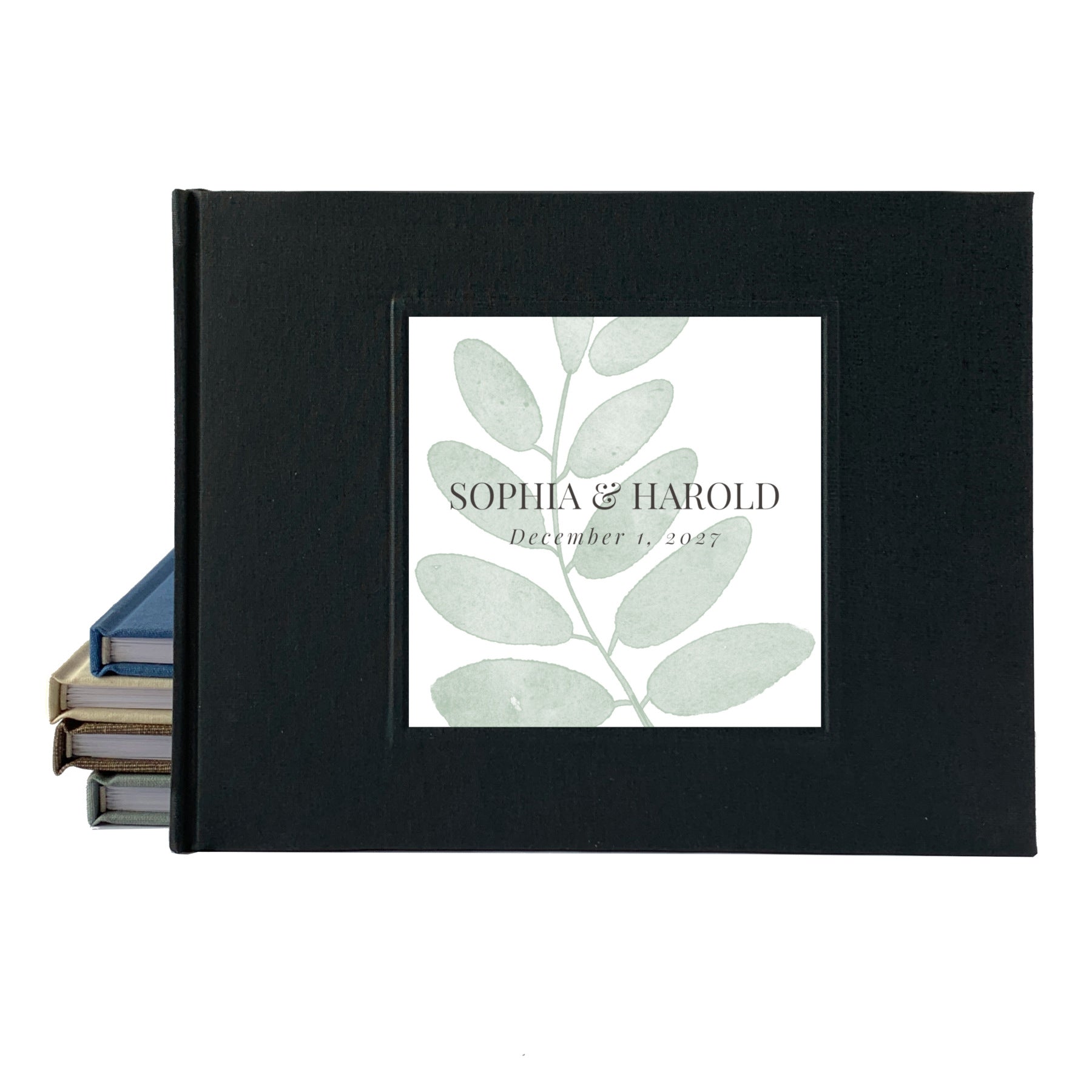 Black linen outdoor wedding guest book with simple leaf personalized on the front with the couple's names and wedding date.