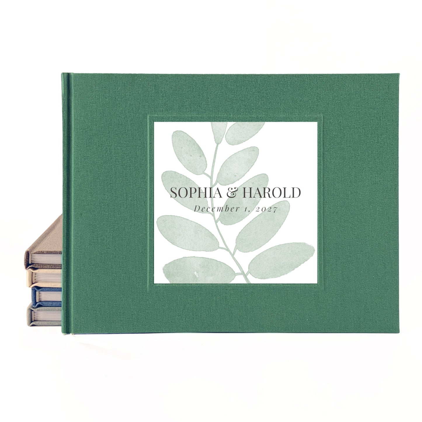 Green linen outdoor wedding guest book with simple leaf personalized on the front with the couple's names and wedding date.