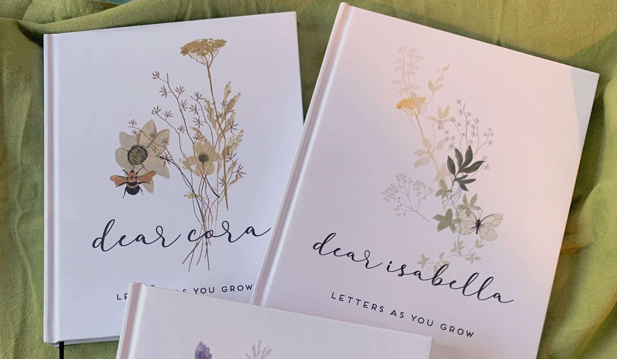 Personalized baby memory books with wildflower artwork and custom names on the cover. Hardback, hand crafted, heirloom quality.
