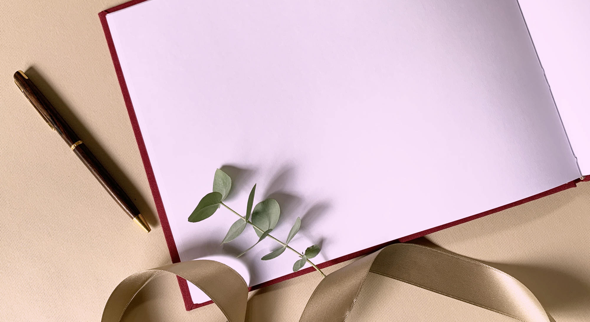 close up of Elegant custom wedding guest book swith textured linen cover open to show the layflat blank  pages.