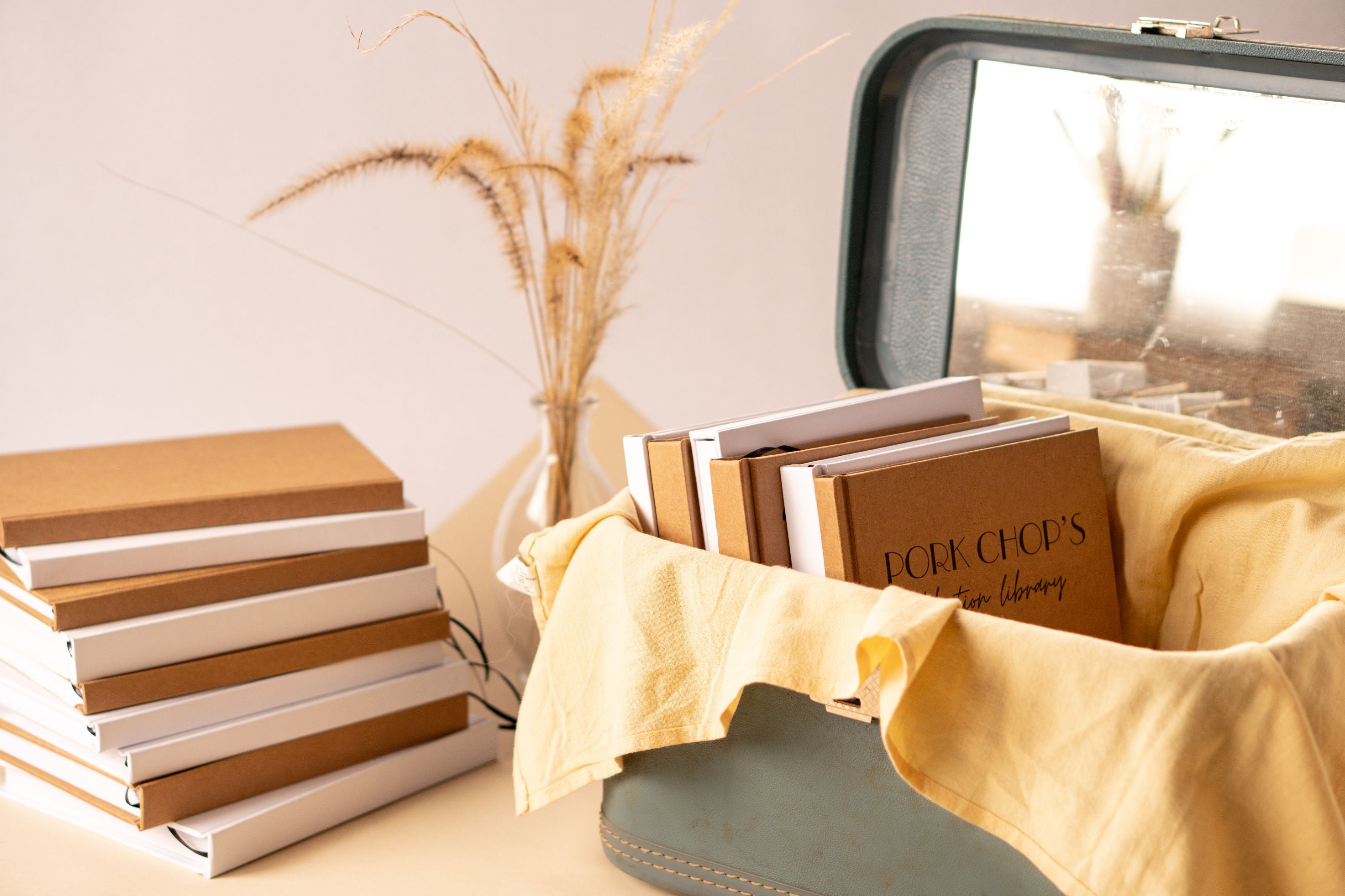 Stacks of beautifully handcrafted personalized journals and custom notebooks, expertly hand-bound and made to order.