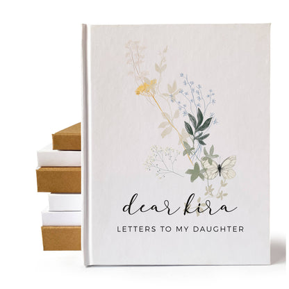 Personalized pregnancy journal for new mom with a white hard back cover, custom text, and a wildflower design.