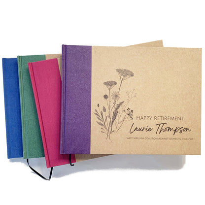 Set of personalized retirement guest books with a variety spine canvas colors. Hardback with personalized wildflower artwork cover design with custom names and text. 