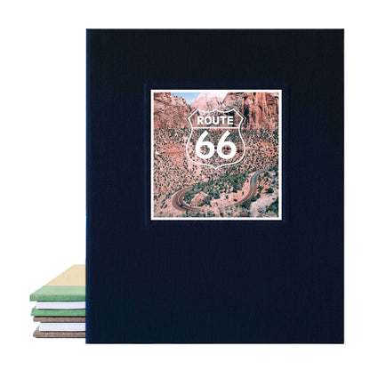 Black linen scrapbook photo album with photo of a usa road trip and route 66 sign.