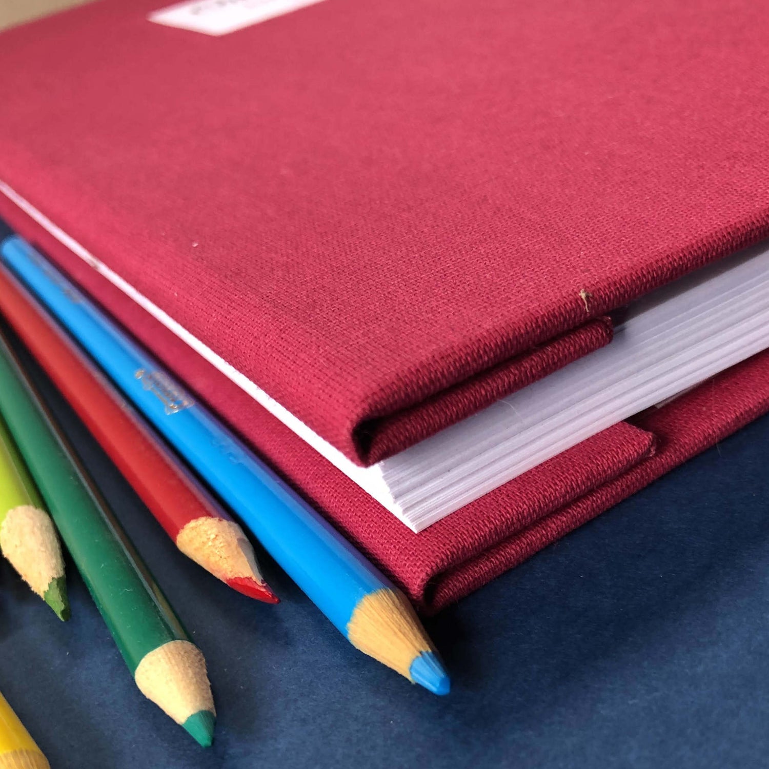 close up of the inverted spine of a Personalized scrapbook album with a hardback burgundy linen cover.
